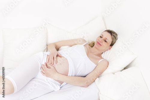 pregnant woman resting in bed