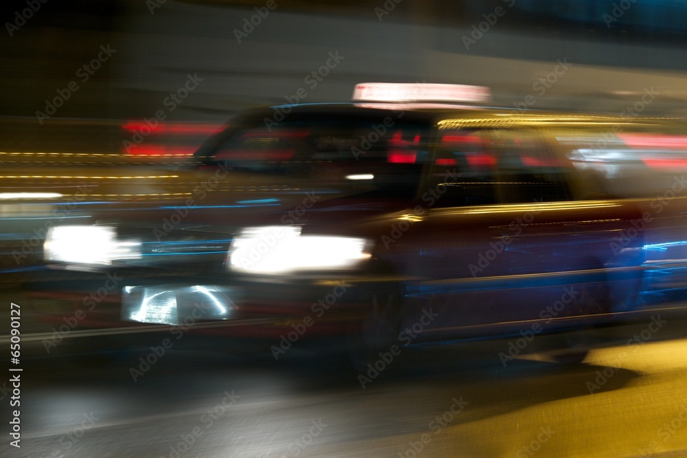 Panning shot of red taxi at night Panning shot of red taxi at night