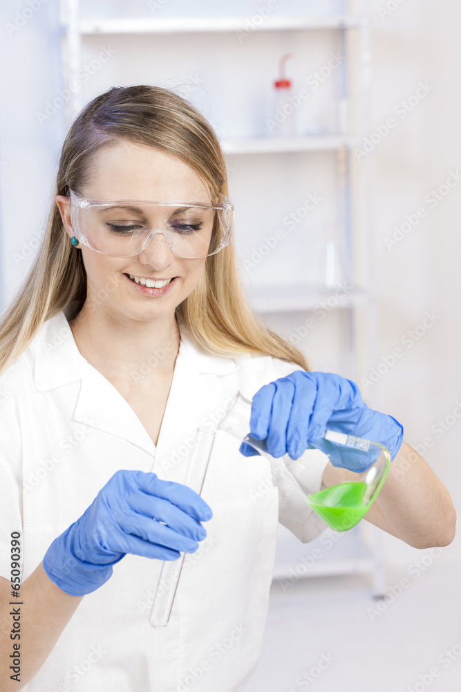 young woman doing experiment in laboratory
