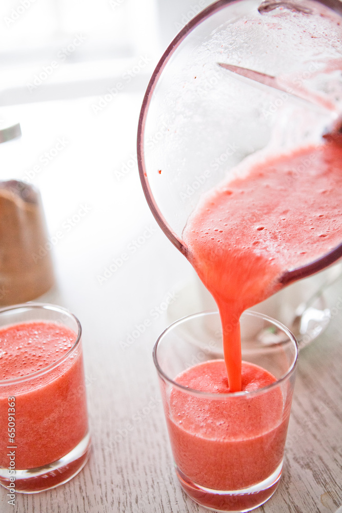 Pouring a delicious strawberry smoothie Pouring a delicious strawberry smoothie