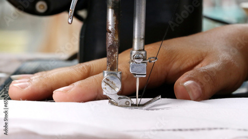 Fototapeta Naklejka Na Ścianę i Meble -  Woman hand, working with sewing machine