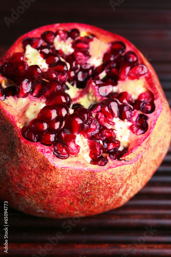 Ripe pomegranate on bamboo mat background