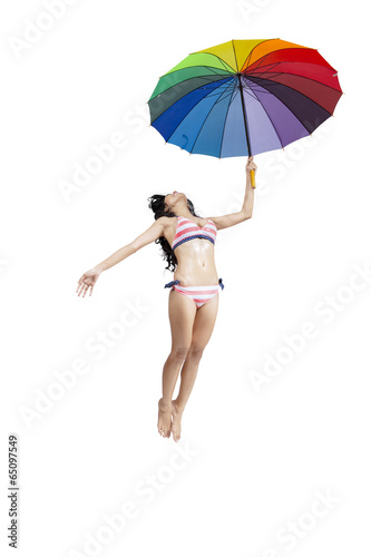 Attractive woman in bikini jumping