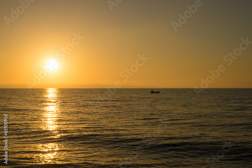 Sunrise with fishing boat