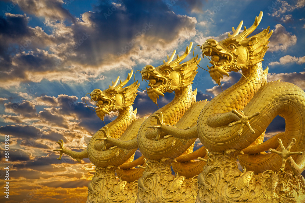 Fototapeta premium Chinese Golden Dragons Statue with sunset