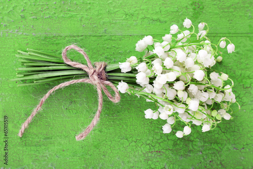 Fototapeta Naklejka Na Ścianę i Meble -  Beautiful lilies of the valley on old wooden background