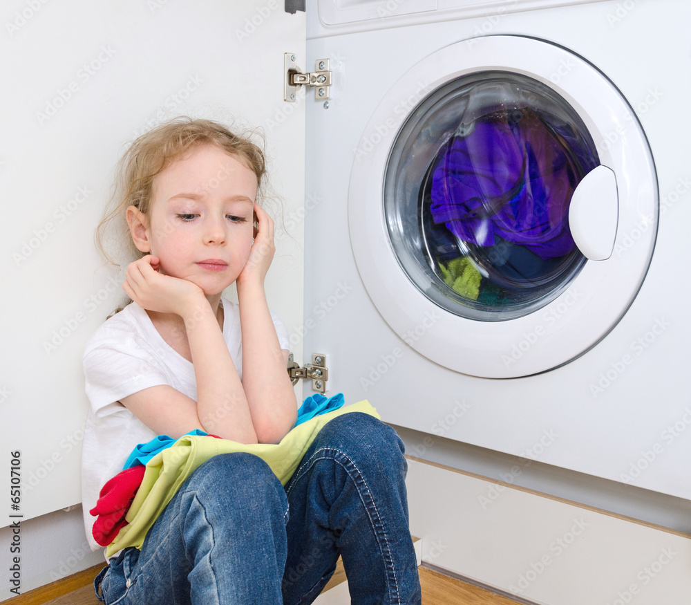 Little girl doing laundry. Housework concept. Little girl doing laundry. Housework concept.