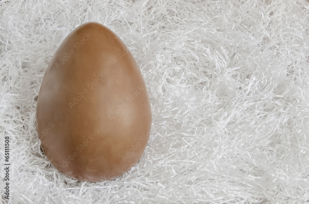 Chocolate Easter egg on a white paper background Chocolate Easter egg on a white paper background