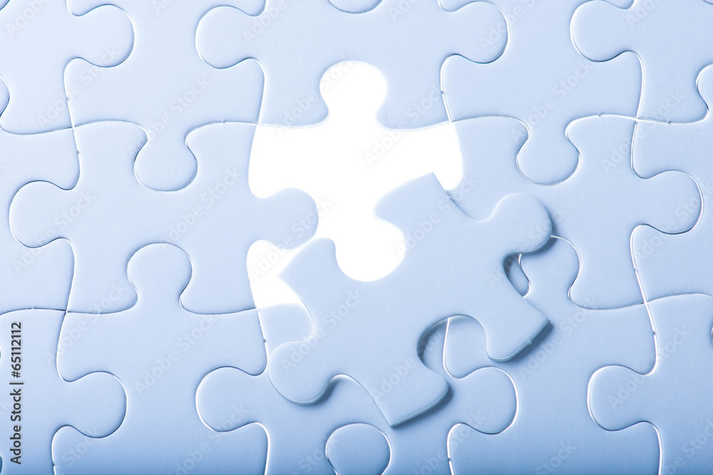 Missing jigsaw puzzle piece with light glow Missing jigsaw puzzle piece with light glow