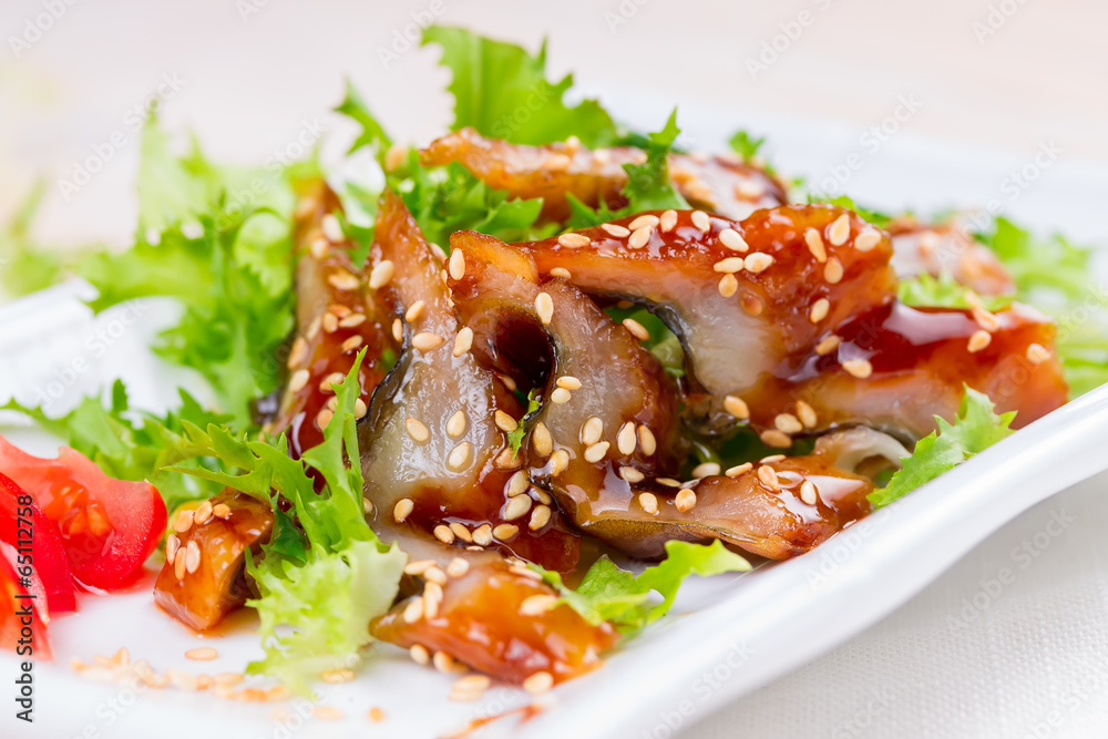 Smoked eel with unagi sauce and sesame seeds Smoked eel with unagi sauce and sesame seeds