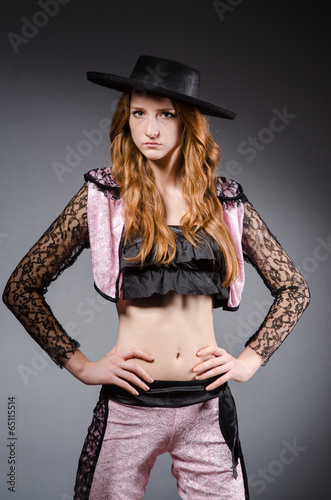 Redhead woman toreador against grey background