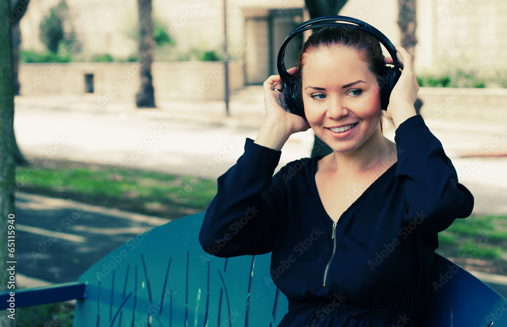 Beautiful Young Woman with Headphones Outdoors Beautiful Young Woman with Headphones Outdoors