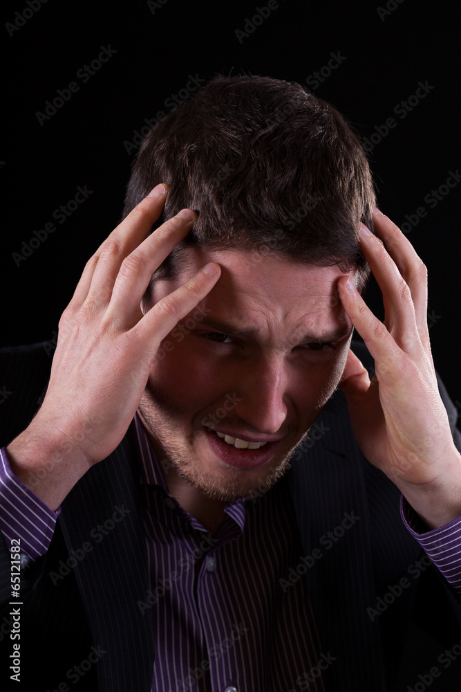 Businessman feeling migraine