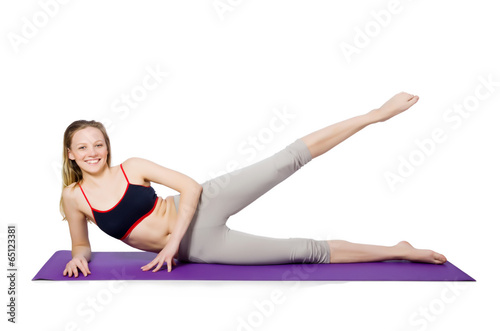 Young female doing exercises on white
