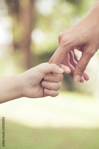 Hands of mother and son © tatomm