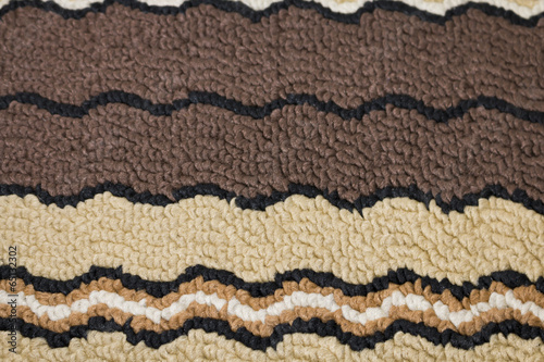 Carpet with brown decoration close-up background texture