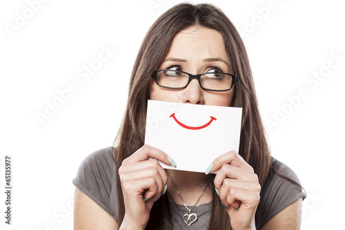sad young woman with smile painted on paper