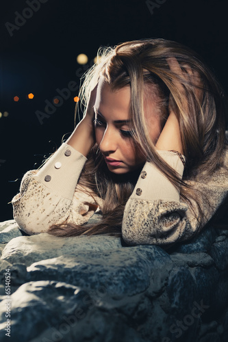 Cute blonde thinking in loneliness halflit