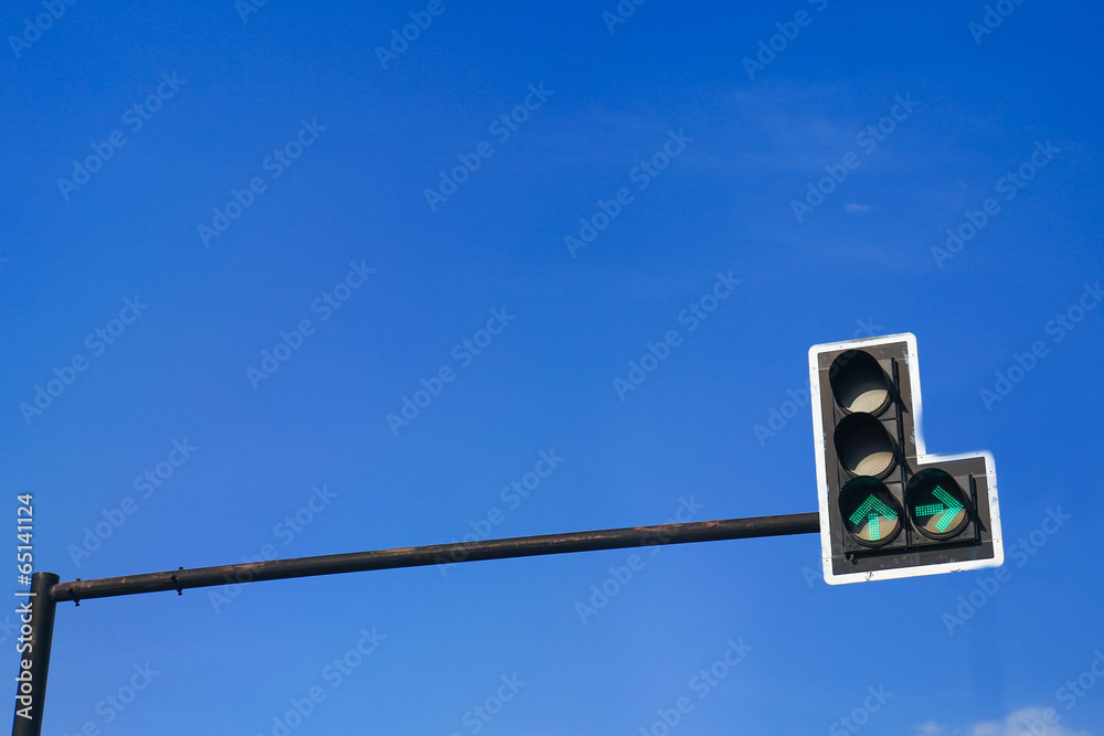 Green color on the traffic light with a beautiful blue sky in ba