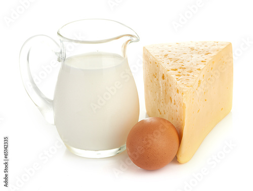 Big piece of cheese, glass jug with milk