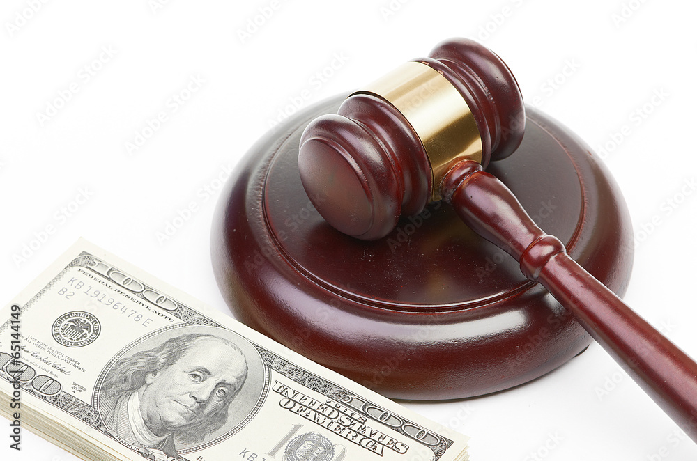 Law gavel on a stack of American money. Law gavel on a stack of American money.