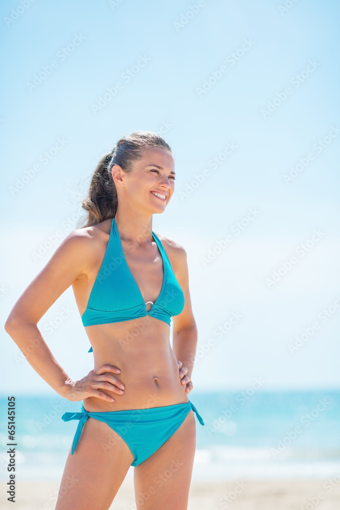 Portrait of happy young woman on beach looking on copy space Portrait of happy young woman on beach looking on copy space