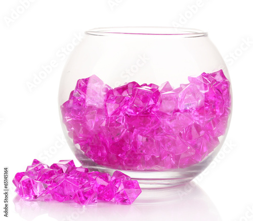 A glass with pink decorative stones isolated on white