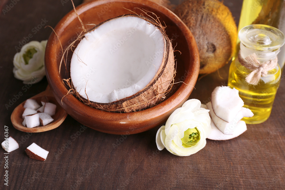 Coconuts and coconut oil on wooden table