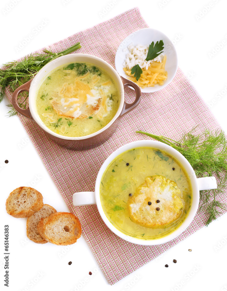 Tasty soup in saucepans, isolated on white Tasty soup in saucepans, isolated on white