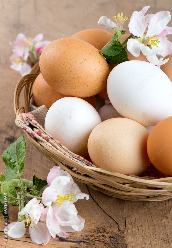beautiful farm eggs and apple blossoms on wooden surface beautiful farm eggs and apple blossoms on wooden surface