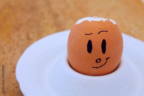 Egg with broken shell and drawn face