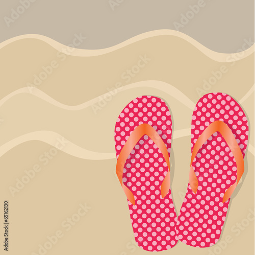 flip flops or sandals on a sandy beach background