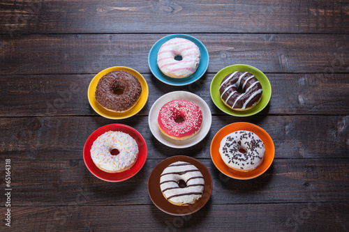 Donuts on wooden table.