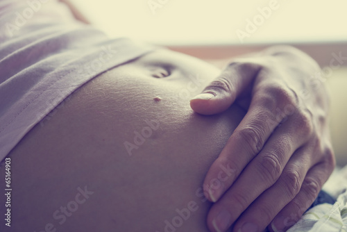 Swollen belly of a pregnant woman