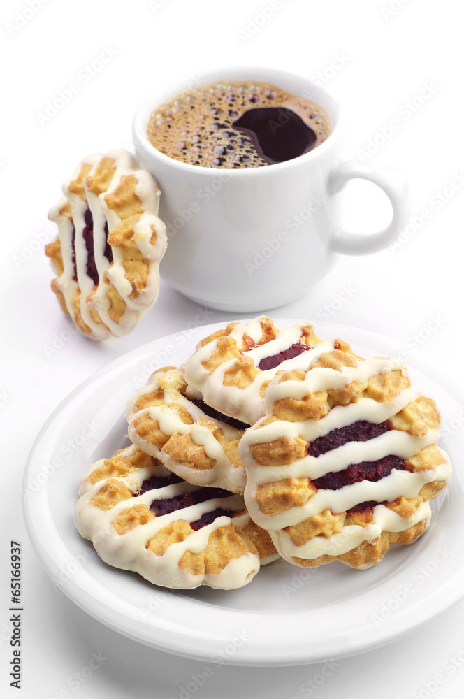 Cookies with jam and icing and cup of coffee Cookies with jam and icing and cup of coffee