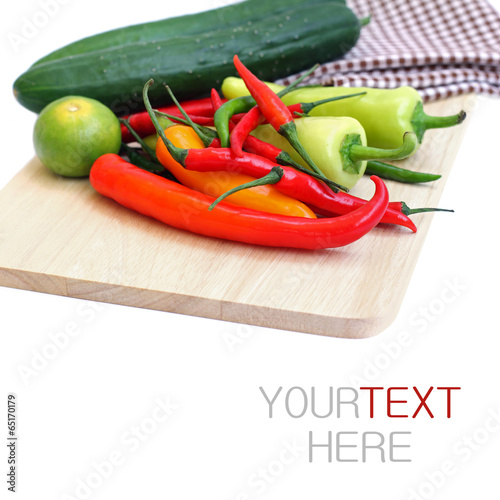 a bunch of chilli, lime and cucumber on chopping board(with samp photo