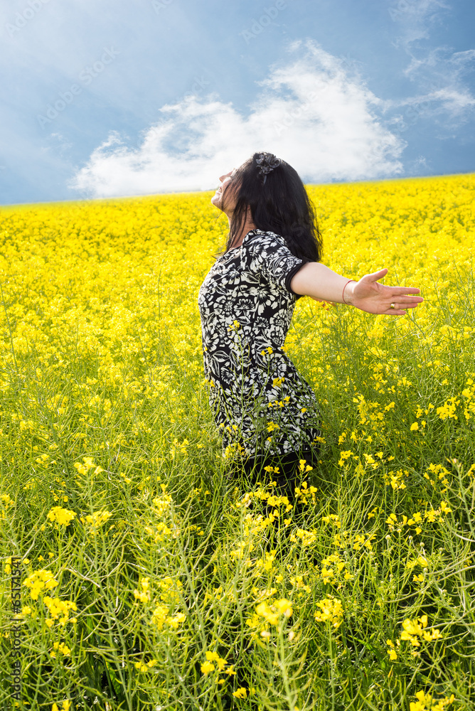 Happy woman in rapeseed field