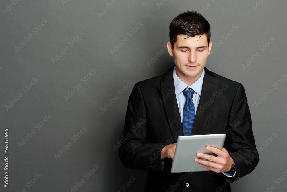 Young businessman using tablet pc Young businessman using tablet pc
