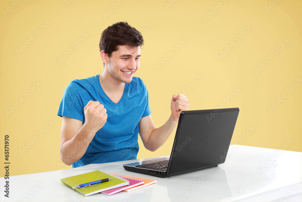 Man with arms raised using laptop Man with arms raised using laptop