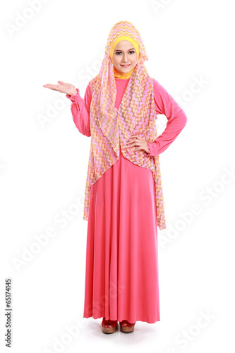 beautiful woman wearing pink muslim dress showing copyspace