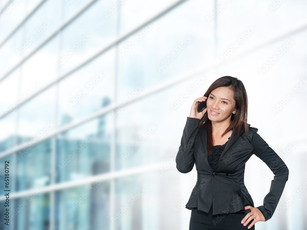 Beautiful young businesswoman and the modern business center Beautiful young businesswoman and the modern business center