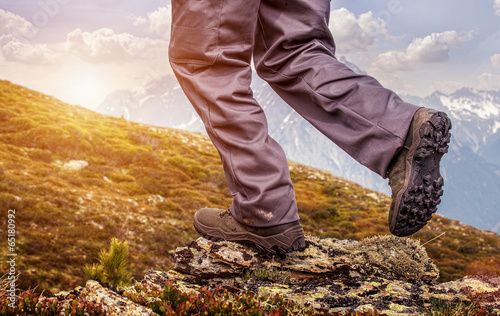 Hiker  standing on top of a mountain and enjoying sunrise