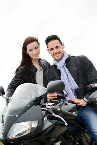 happy young lovers couple riding a motorbike on a vacation trip