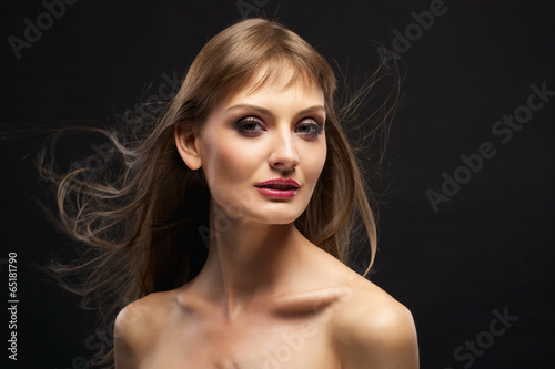 pretty girl with bare shoulders and flying hair