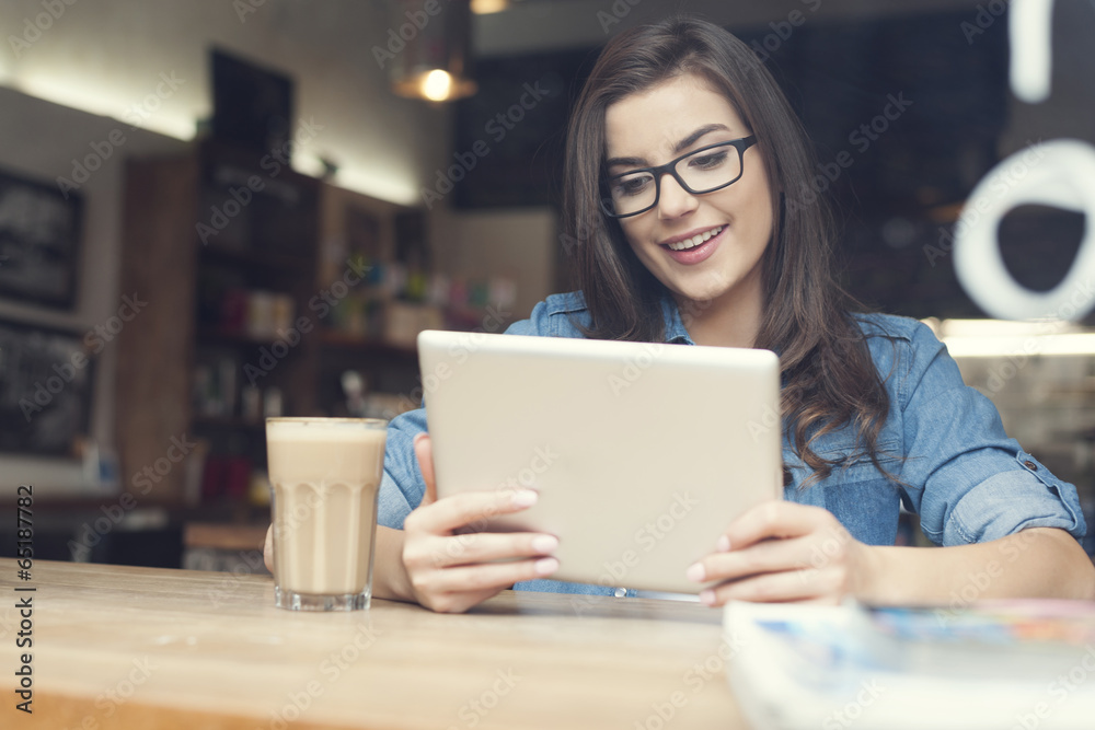 Beautiful woman using digital tablet at cafe