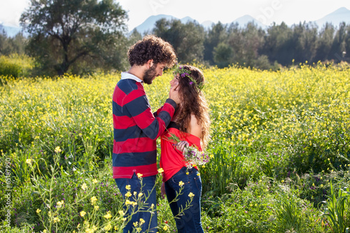 Loving young couple in a rapeseed field. © belahoche