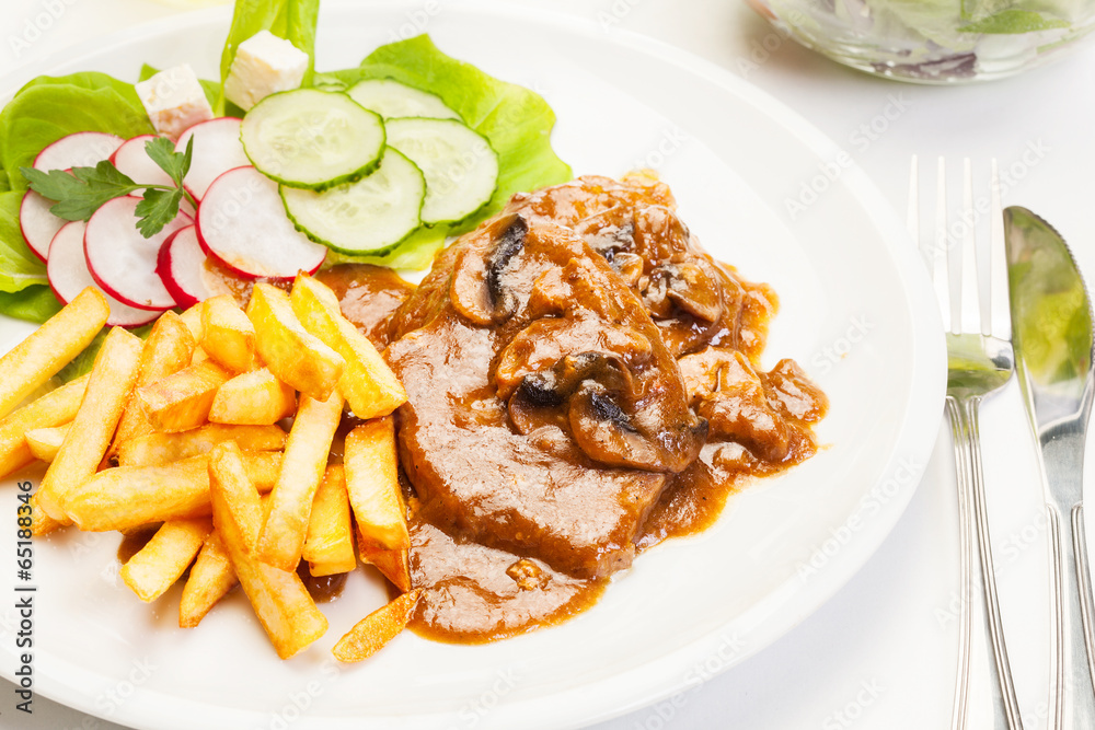 Pork chop with sauce, mushrooms and chips Pork chop with sauce, mushrooms and chips