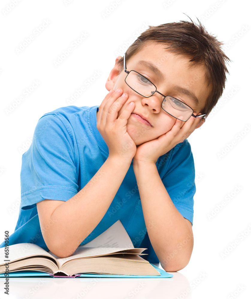 Little boy is tired to read his book Little boy is tired to read his book