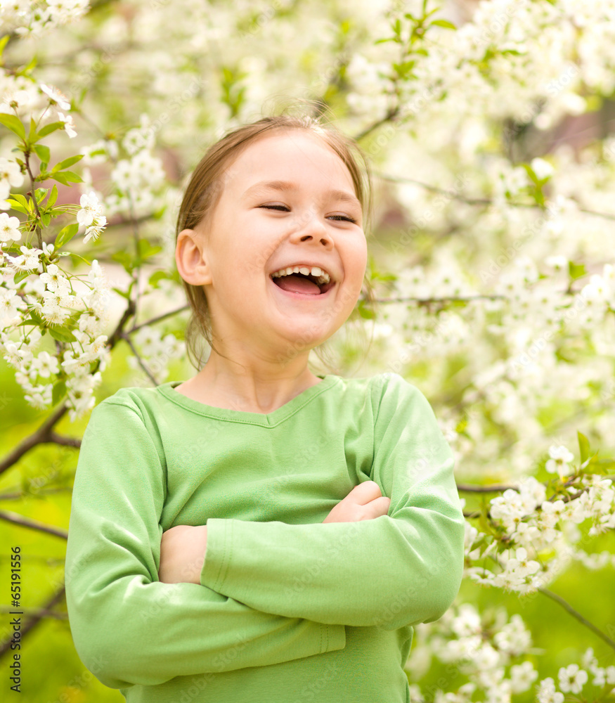 Portrait of a little girl near tree in bloom Portrait of a little girl near tree in bloom