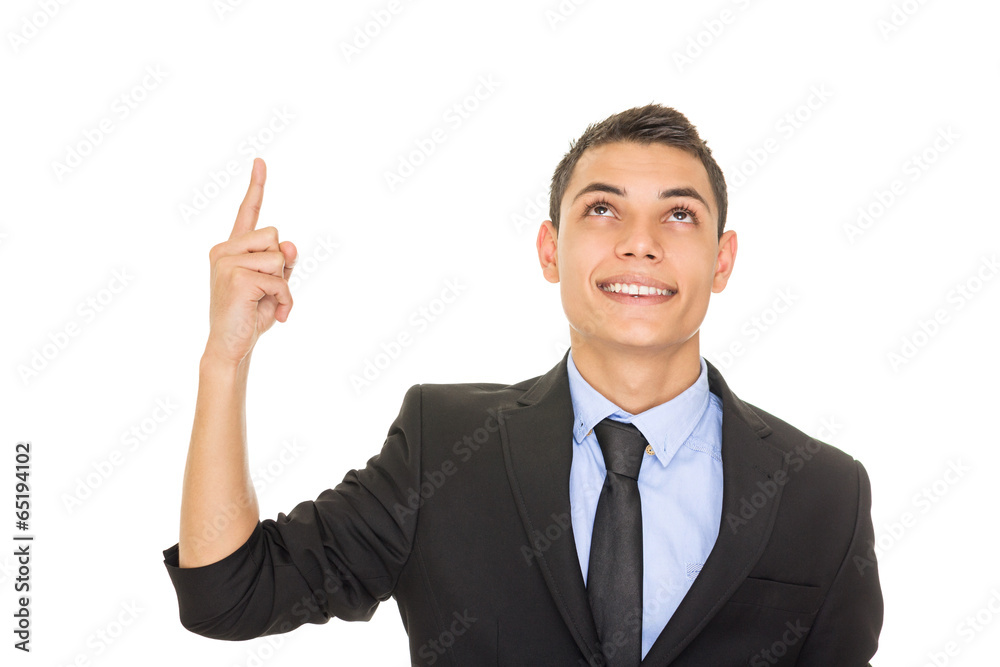 Happy young Hispanic businessman looking and pointing up Happy young Hispanic businessman looking and pointing up